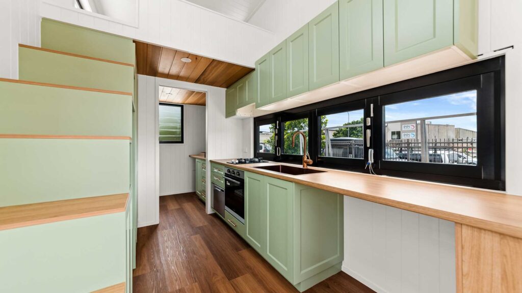 Tiny House kitchen with green cabinetry